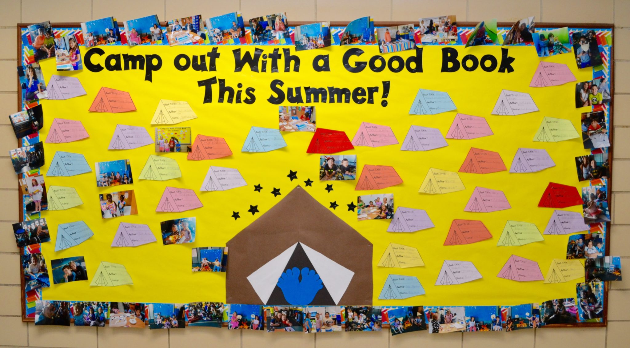 Clarke school bulletin board - camp out with a good book this summer. Shows mini tents and a large tent and students reading